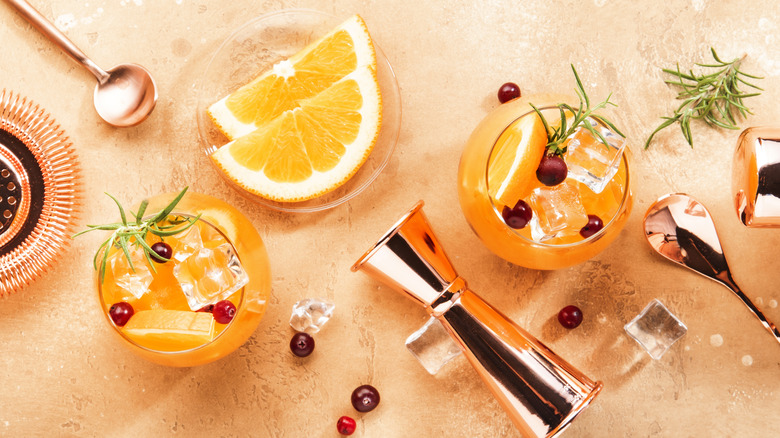 Orange ciders with cocktail tools