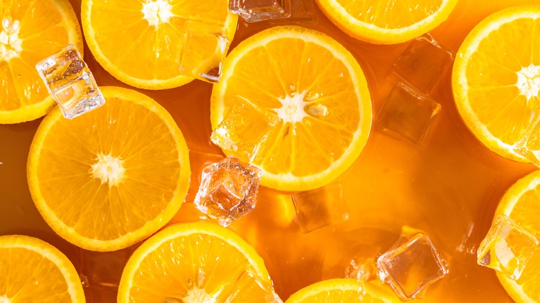 Sliced oranges in liquid with ice