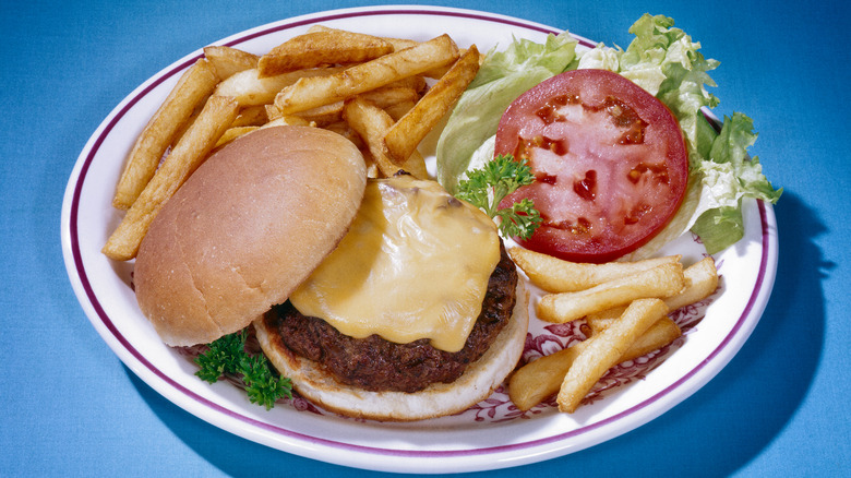 cheeseburger with fries, lettuce, tomato