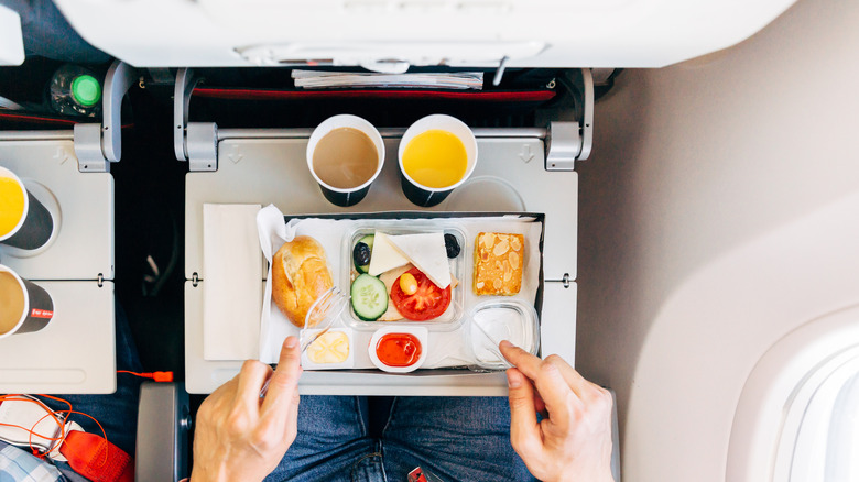 person eating snacks on an airplane