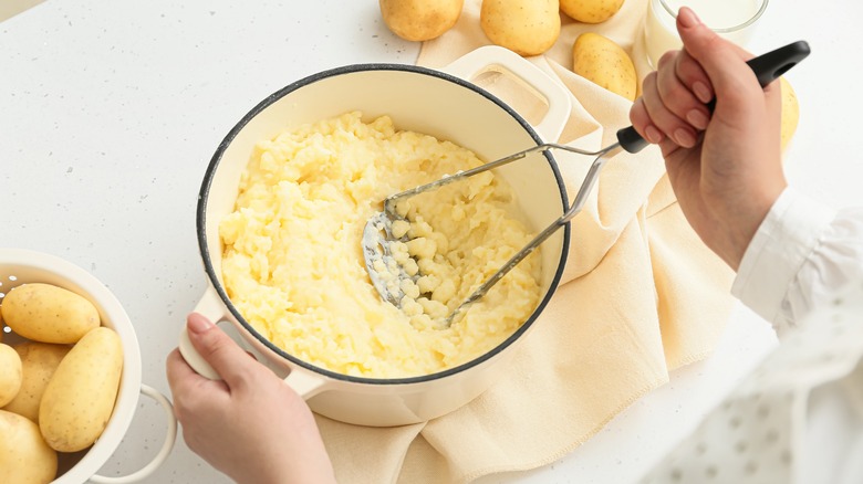 woman mashing potatoes