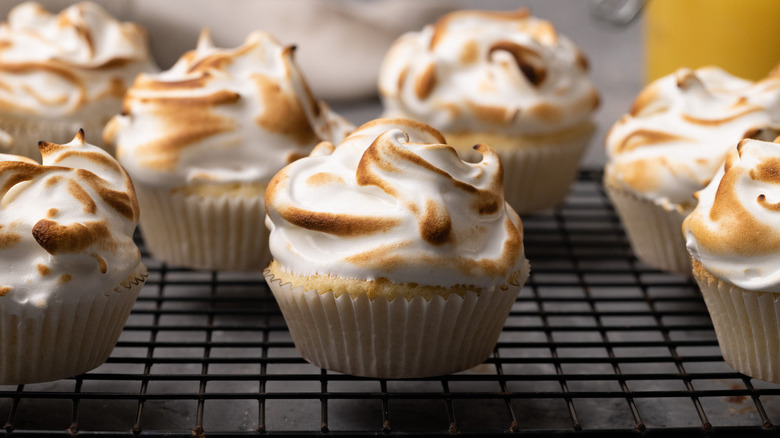 Lemon meringue cupcakes on rack