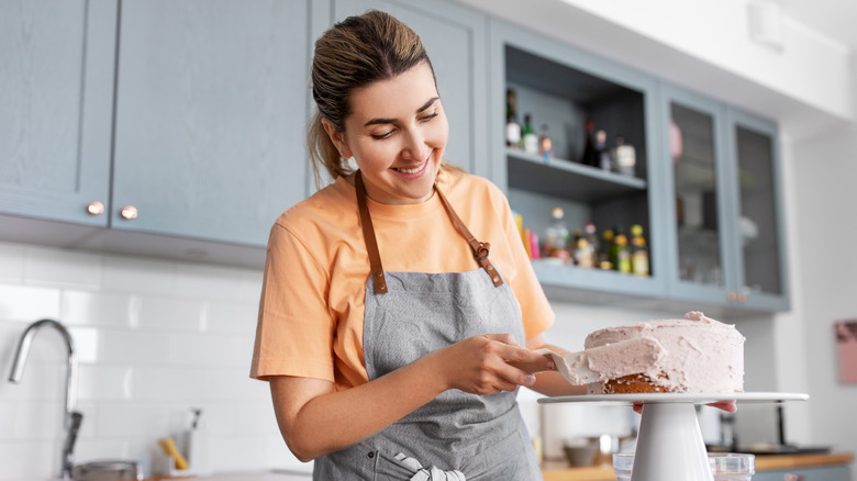 Woman frosting a cake