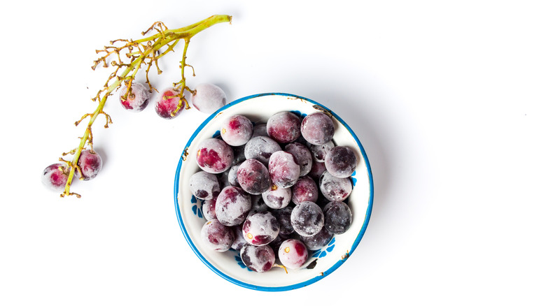 A bowl of frozen grapes