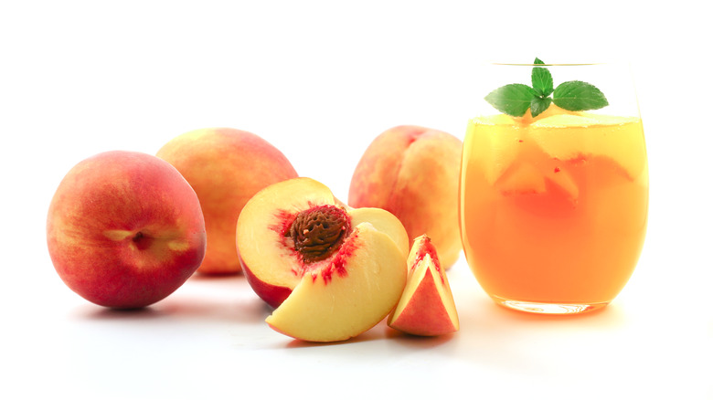 glass of fresh peach juice and peaches