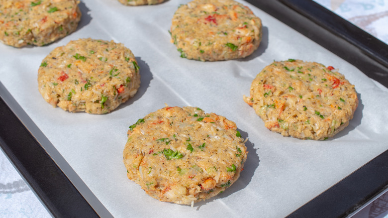 uncooked crab cakes on baking sheet