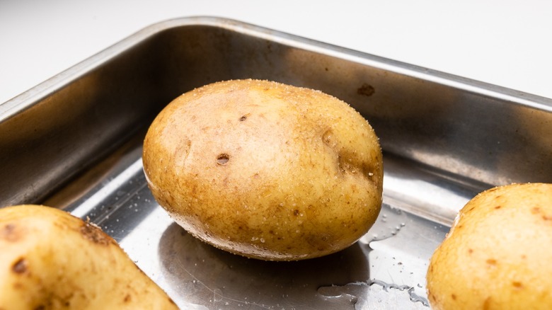 Slow-baked potatoes in pan