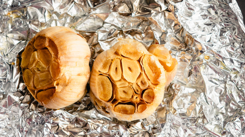 Roasted garlic bulbs on aluminum foil