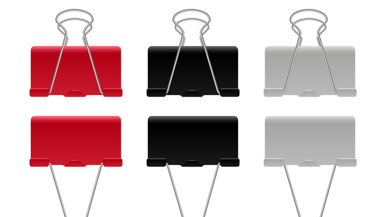 Colorful binder clips on a white background