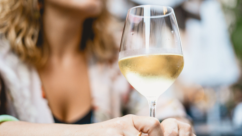 woman drinking wine with lipstick mark on glass