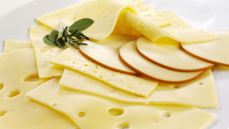 slices of different varieties of cheese on a white background