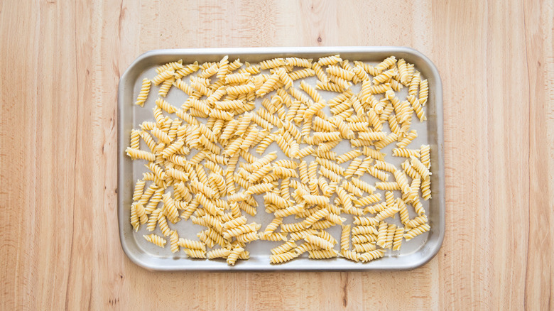 fusilli spread on baking sheet