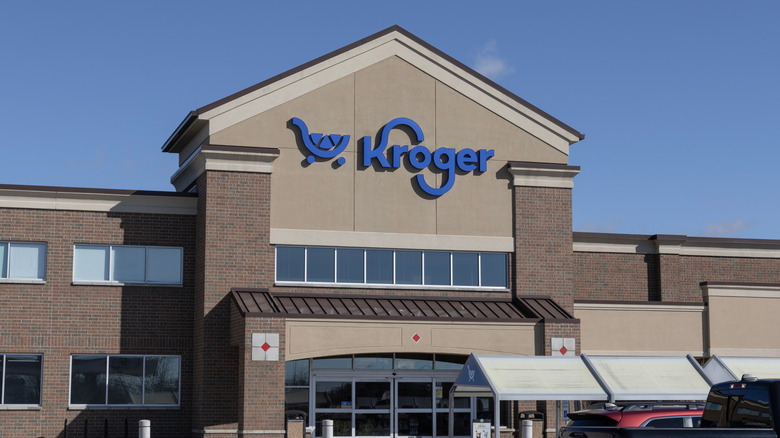 A close up of a Kroger sign on a storefront