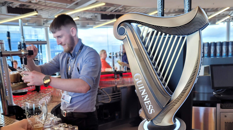 A bartender pouring Guinness at the Guinness Storehouse