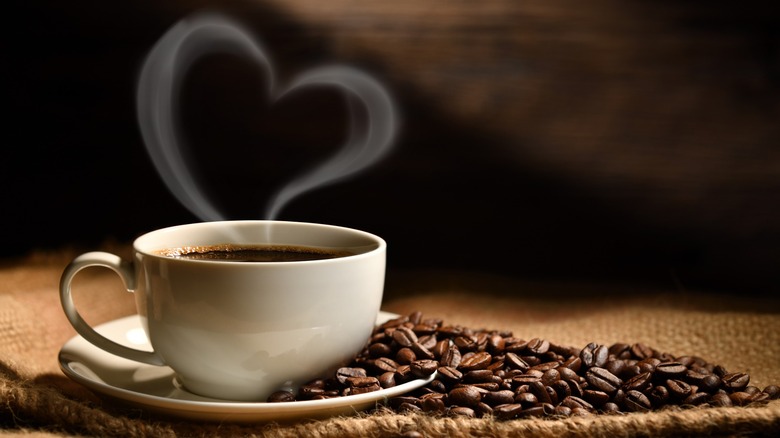 Mug of coffee with heart-shaped steam above it