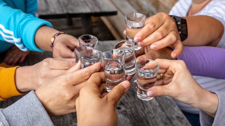 Several clear shots being toasted