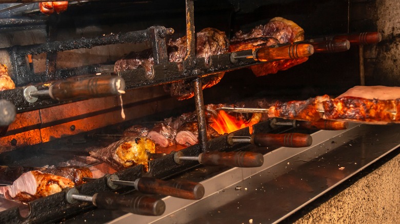 different cuts of Brazilian meat in a fire pit at  a Churascaria