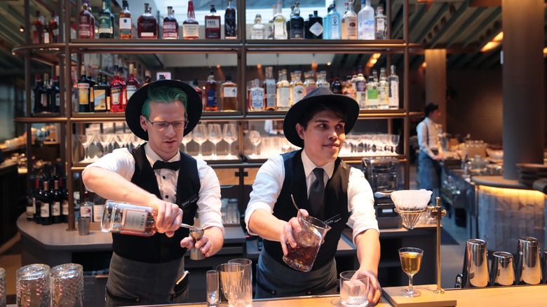 Two Starbucks Reserve baristas serving drinks