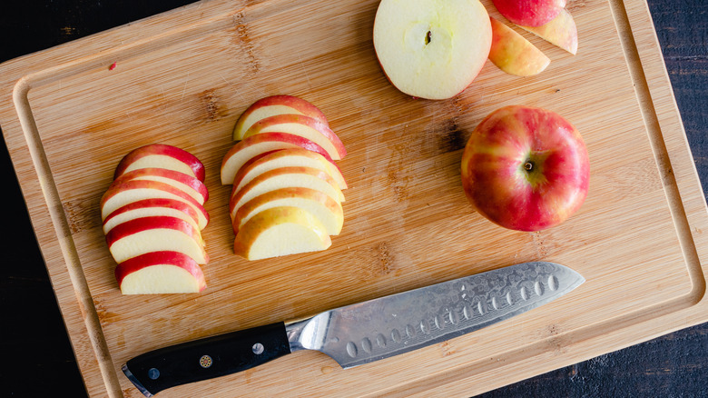 sliced Honeycrisp apples on board