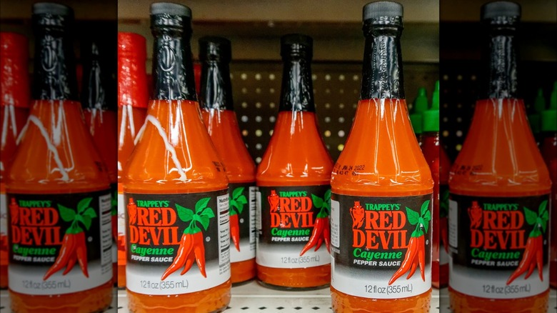 Bottles of Red Devil sauce on shelf