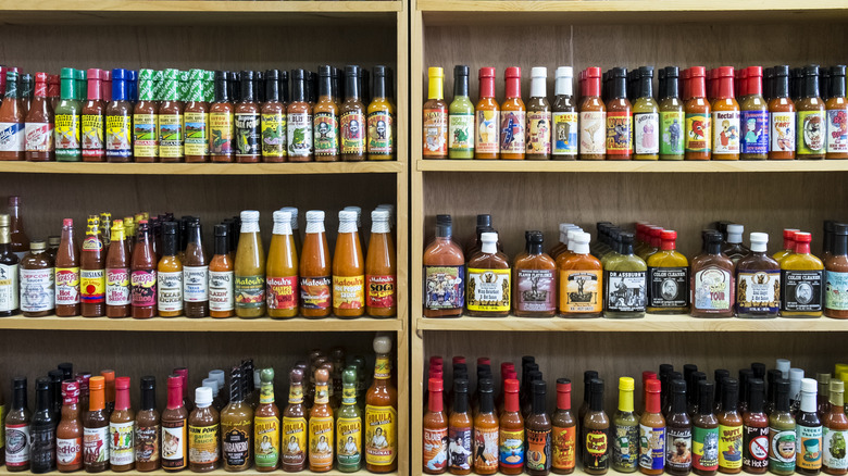 Shelf full of hot sauces