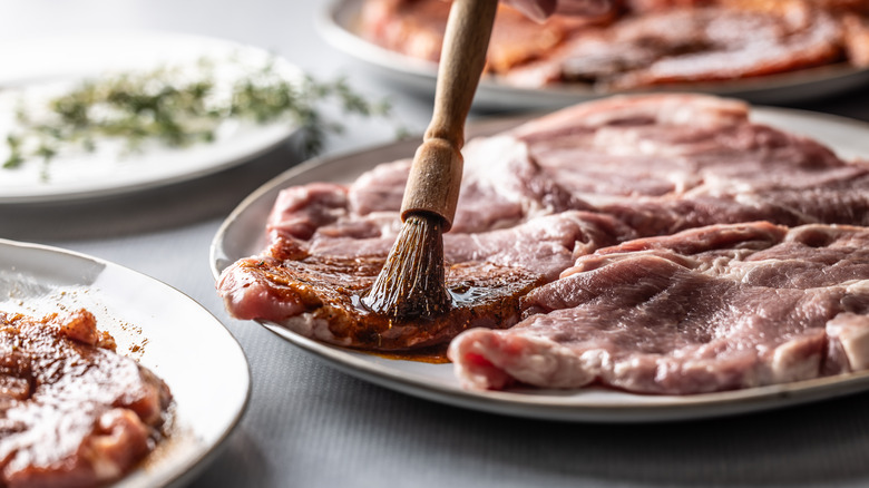 brushing steak with marinade