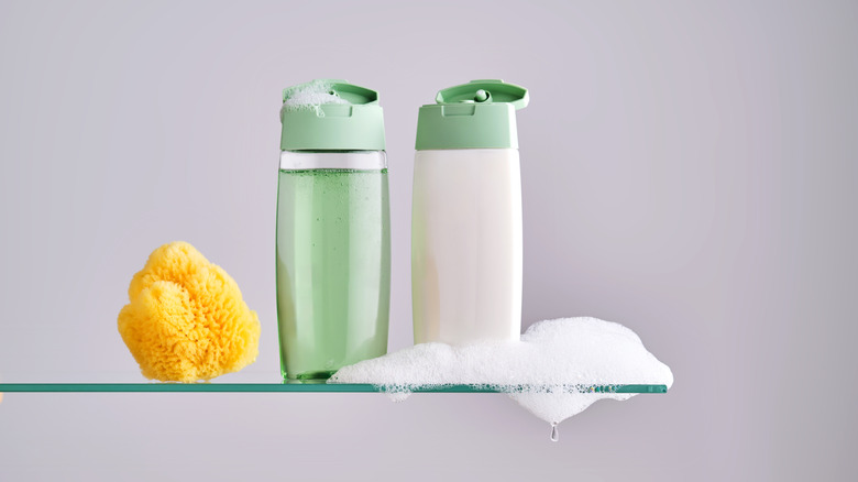 Shampoo and conditioner side by side, foaming with sponge on the side