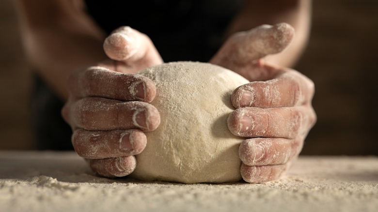 hands kneading dough 