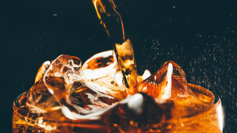 A closeup of a soft drink poured into a glass