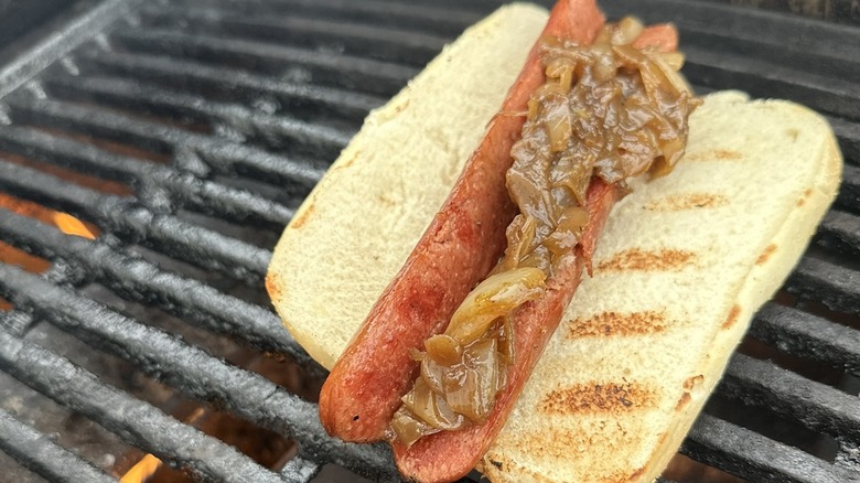 Hot dog with onions on grill