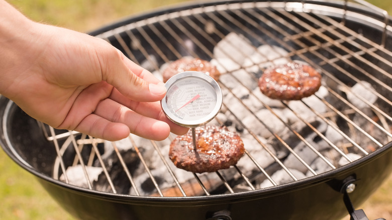 thermometer checking burger temperatures