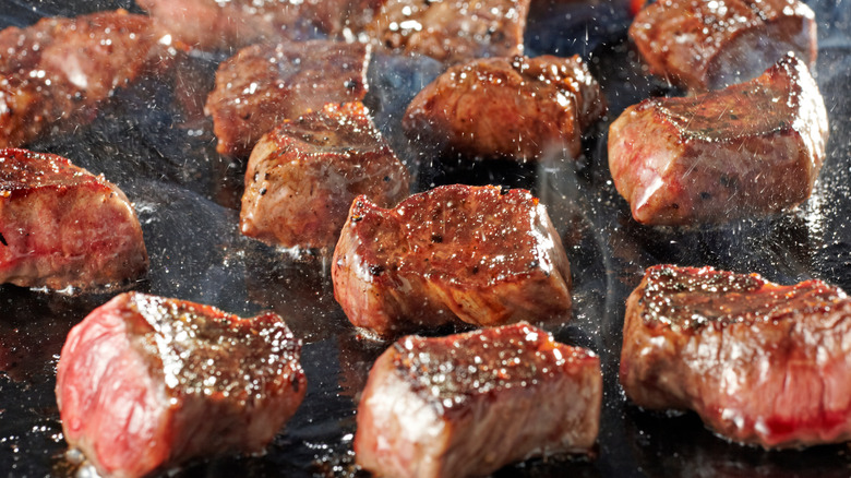 Close up of steak tips cooking 