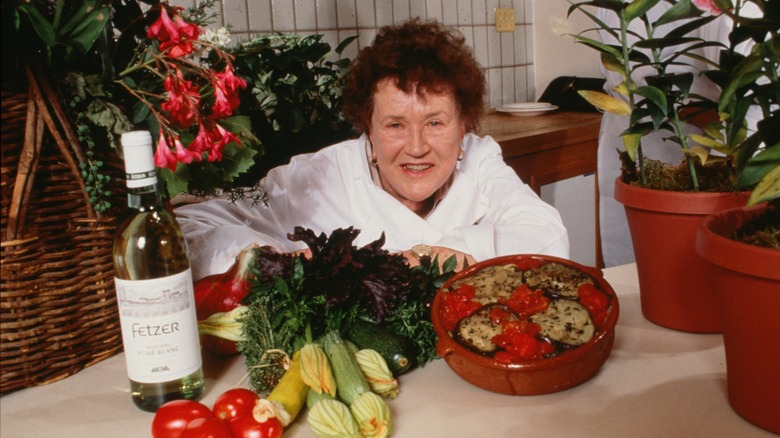 Julia Child surrounded by vegetables