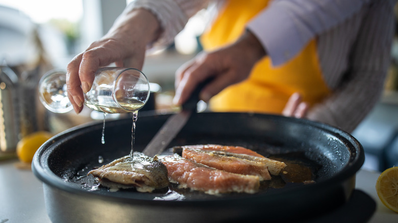 adding wine to fish