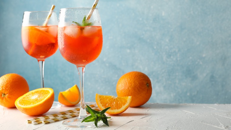 Two Aperol spritz cocktails with oranges