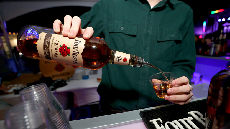 bartender pouring four roses bourbon