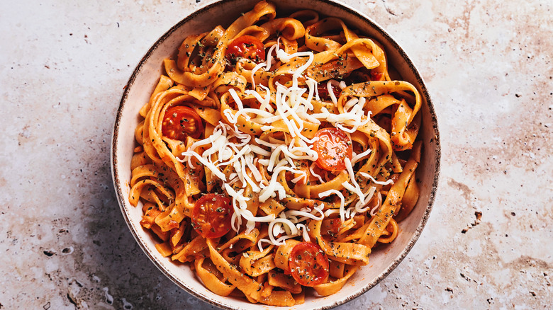 bowl of pasta with tomatoes and cheese