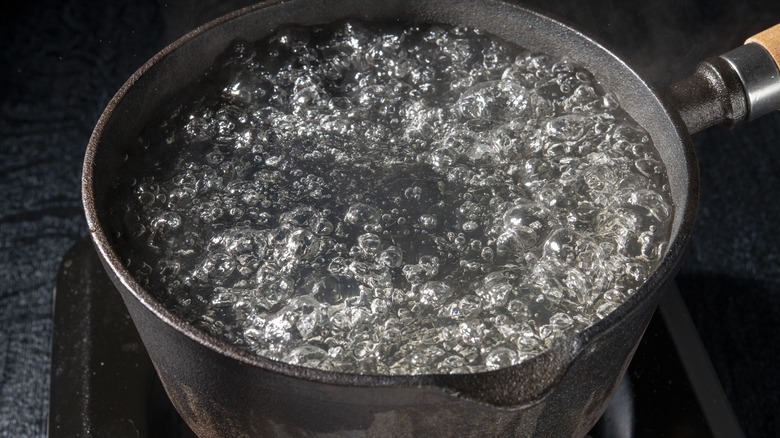 water boiling in a cast iron pot