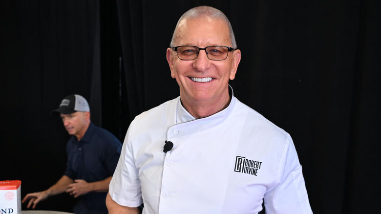 Robert Irvine, smiling in glasses