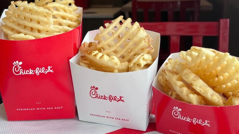 Three cartons of Chick-fil-A waffle fries