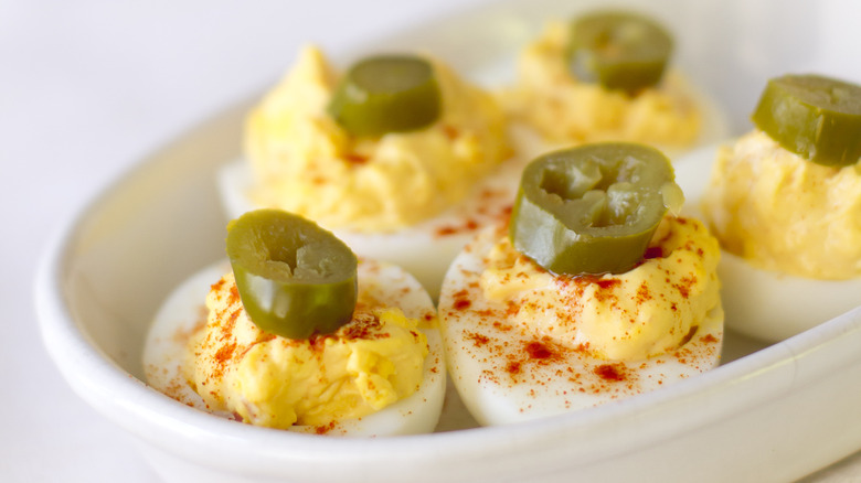 Deviled eggs topped with jalapeno