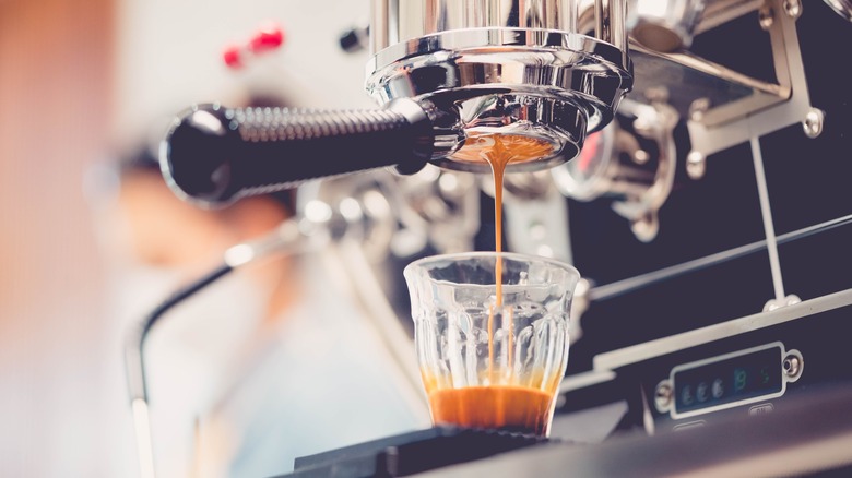 Ristretto shot brewing into a glass from an espresso machine 