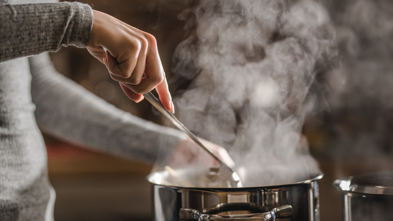 Spoon stirring pot of soup