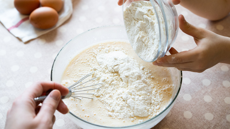 Pouring flour in batter