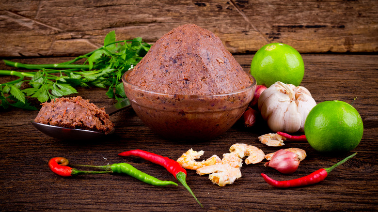 Shrimp paste in a glass bowl surrounded by ingredients