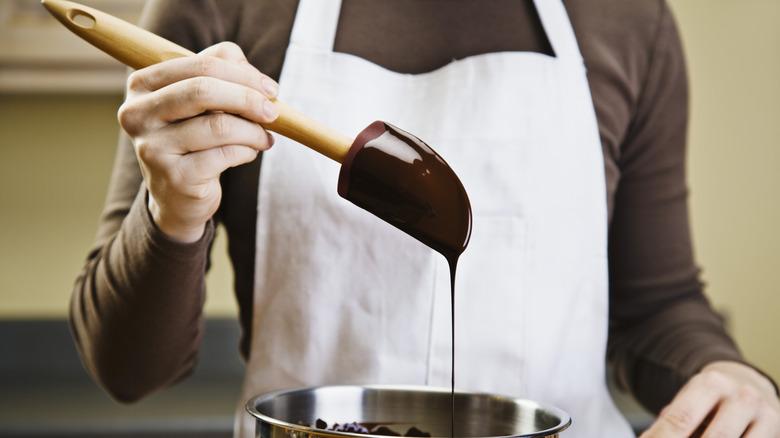 Melted chocolate dripping off spatula