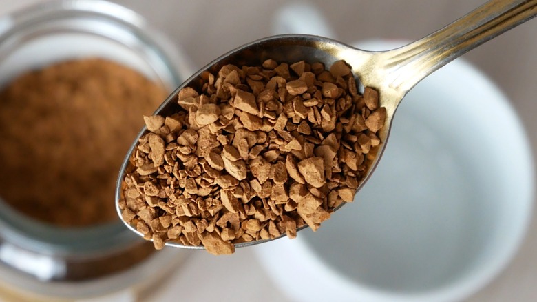 Close-up of a spoonful of dry instant coffee granules