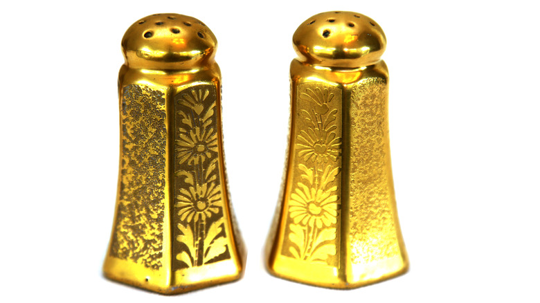 Gold salt shakers with floral pattern