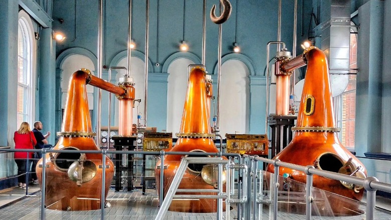 tourists seeing distillery equipment