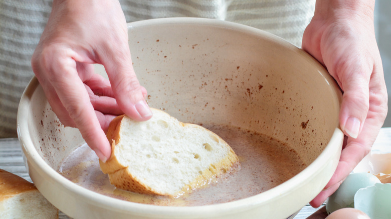 hands dipping toast into mixture